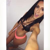 Bruna Lima in a bikini taking a selfie