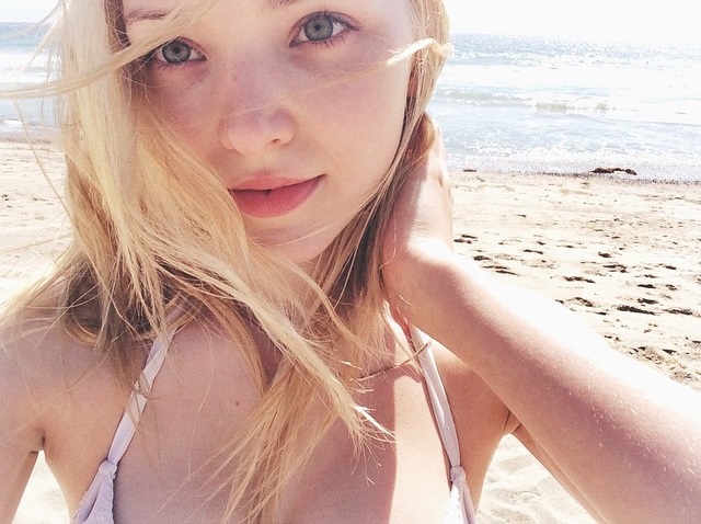 Dove Cameron in a bikini taking a selfie