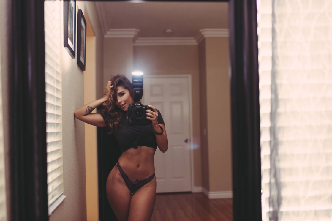 Tianna Gregory in a bikini taking a selfie