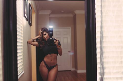 Tianna Gregory in a bikini taking a selfie