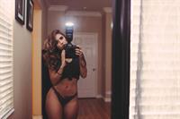 Tianna Gregory in a bikini taking a selfie