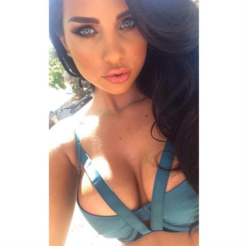 Ann Denise in a bikini taking a selfie