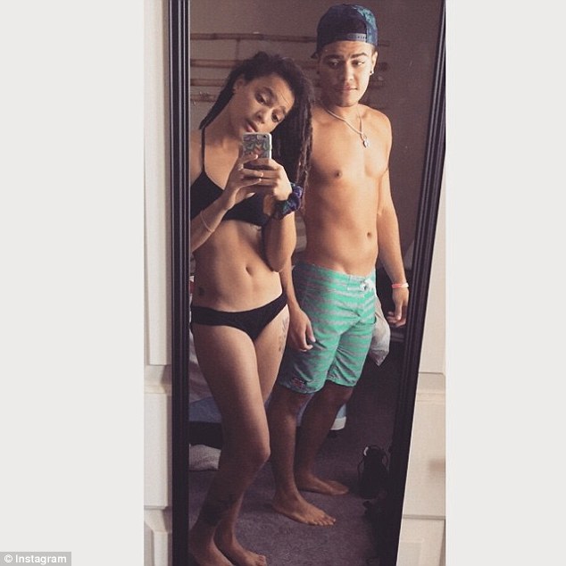 Sasha Lane in a bikini taking a selfie