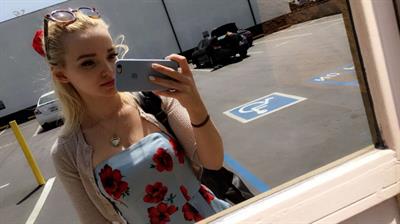 Dove Cameron taking a selfie