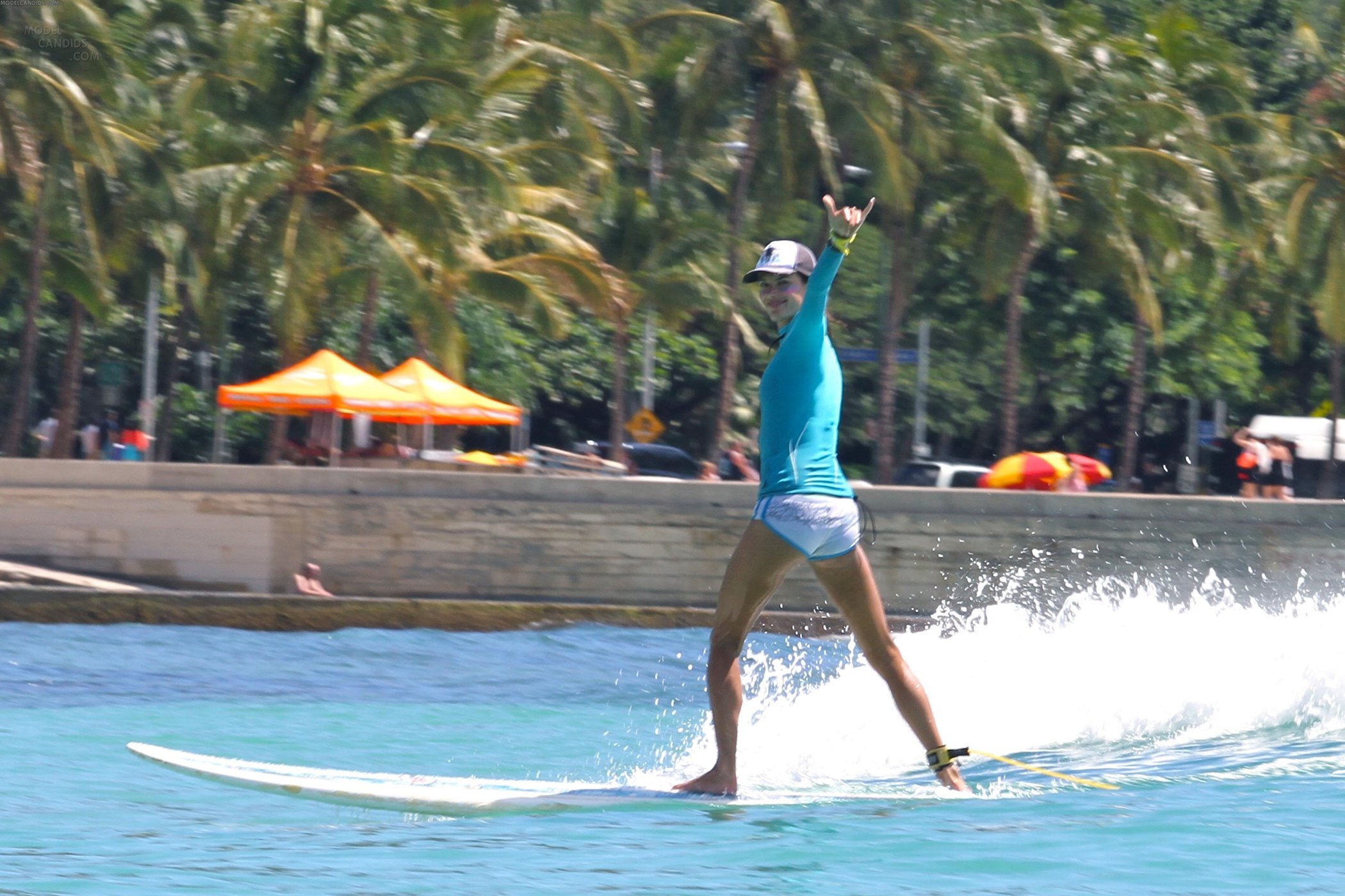 Alessandra Ambrosio surfing and eating a sno cone in Hawaii on October 12, 2011 