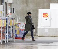 Dannii Minogue - Pictured getting a little wet while filling up on petrol - 09th August 2012