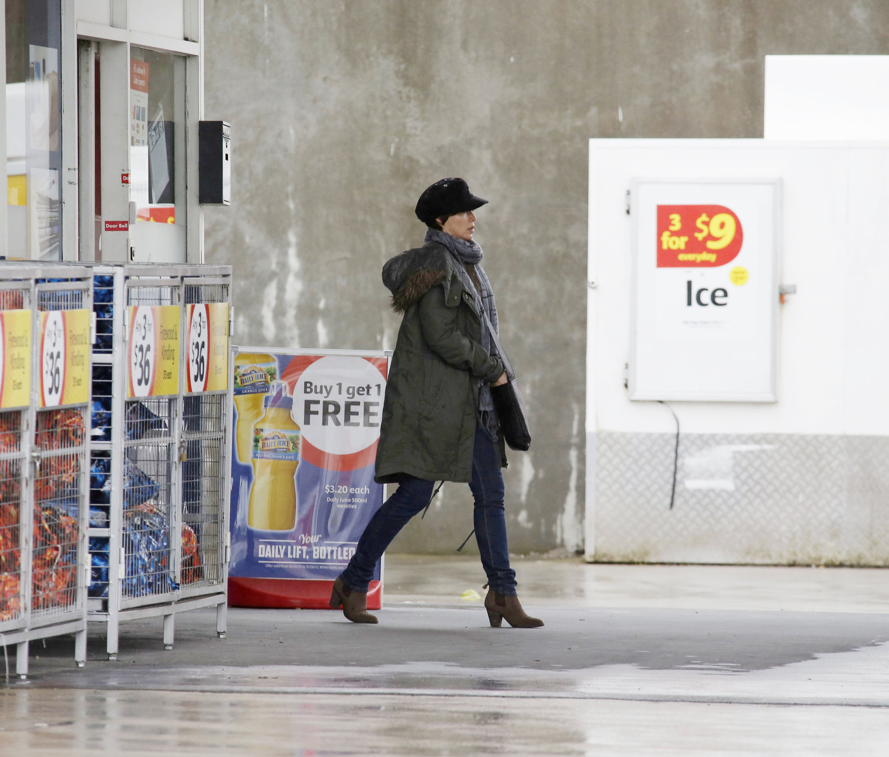 Dannii Minogue - Pictured getting a little wet while filling up on petrol - 09th August 2012