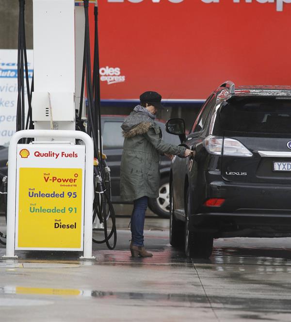 Dannii Minogue - Pictured getting a little wet while filling up on petrol - 09th August 2012