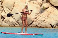 Victoria Silvstedt wearing a bikini on a board in Sardinia on August 8, 2012