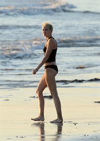 Miley Cyrus  yoga in black bikini on beach in Hawaii 1/24/13 