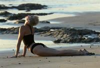 Miley Cyrus  yoga in black bikini on beach in Hawaii 1/24/13 