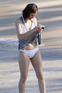 Milla Jovovich on the beach in a bikini on New Years Eve in Maui, Hawaii December 31, 2012 