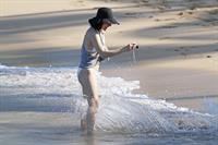 Milla Jovovich on the beach in a bikini on New Years Eve in Maui, Hawaii December 31, 2012 