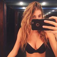 Camila Morrone in a bikini taking a selfie