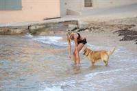 Kimberley Garner in a black bikini on the beach in St. Tropez on July 31, 2014