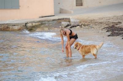 Kimberley Garner in a black bikini on the beach in St. Tropez on July 31, 2014
