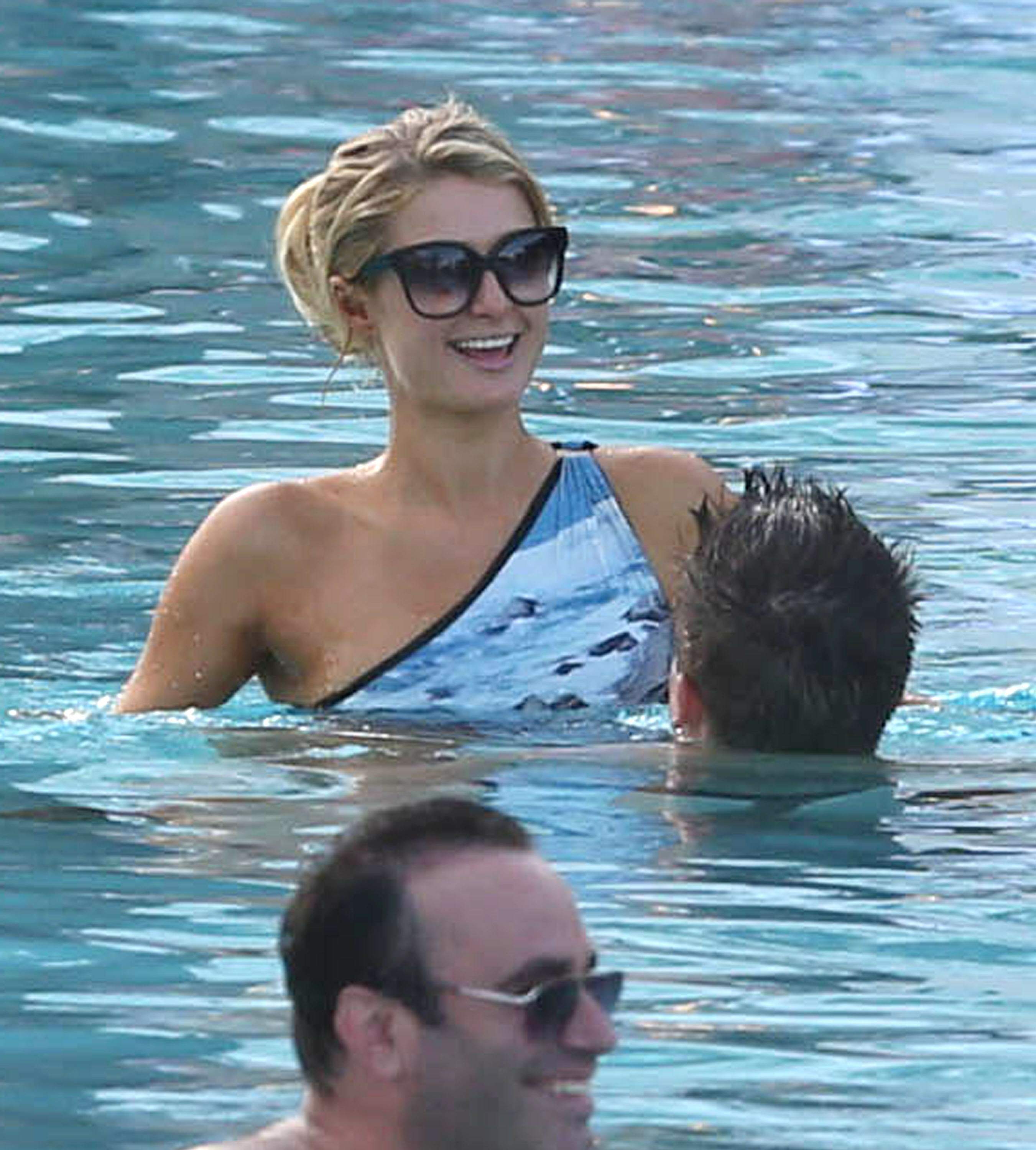 Paris Hilton spends the day in and out of the pool in Miami December 8, 2012