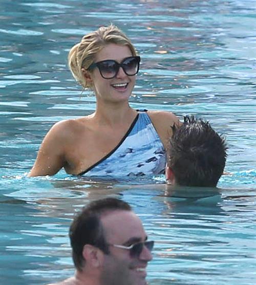 Paris Hilton spends the day in and out of the pool in Miami December 8, 2012
