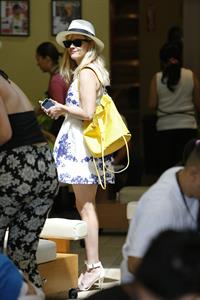 Reese Witherspoon talking and walking after leaving a hair salon in Beverly Hills on August 8, 2014