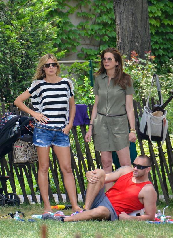Heidi Klum in a black and white striped shirt, spends a day out in a park in Tribeca on June 30, 2013 