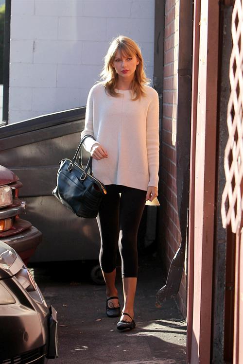 Taylor Swift wearing a white top and black pants in Los Angeles 10/28/13  