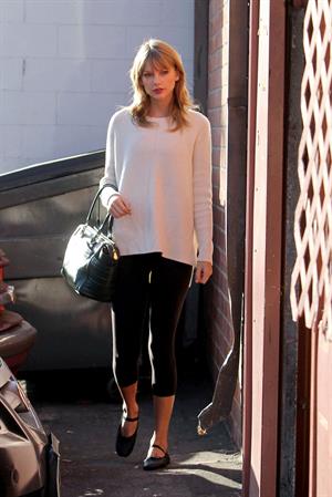 Taylor Swift wearing a white top and black pants in Los Angeles 10/28/13  