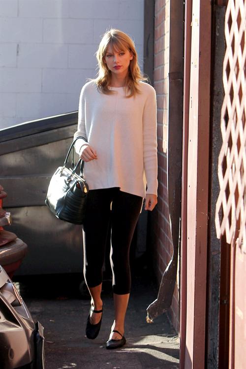 Taylor Swift wearing a white top and black pants in Los Angeles 10/28/13  