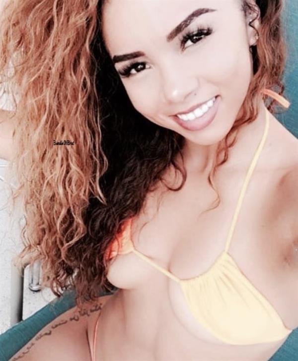 Brittany Renner in a bikini taking a selfie