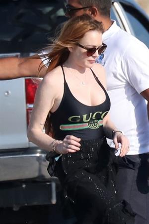 Lindsay Lohan showing nice cleavage with her big boobs in a Gucci swimsuit seen by paparazzi.





















