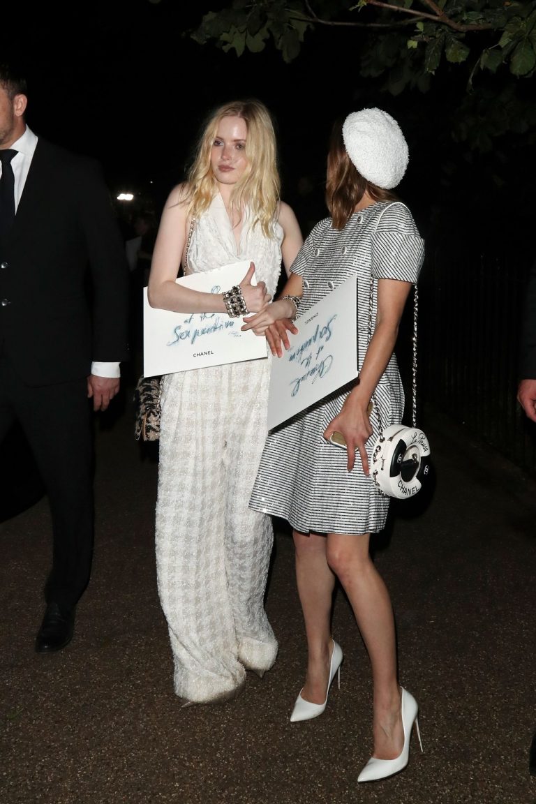 Ellie Bamber Pictures Ellie Bamber braless boobs while wearing basically a scarf as a top showing side boob cleavage.