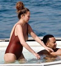 Chrissy Teigen sexy cleavage and ass in a swimsuit with her husband John Legend seen by paparazzi.
