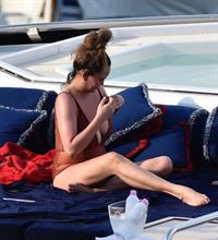 Chrissy Teigen sexy cleavage and ass in a swimsuit with her husband John Legend seen by paparazzi.
