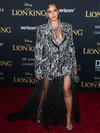 Beyonce braless boobs and areola peek showing off nice cleavage on the red carpet for the premiere of  The Lion King .






