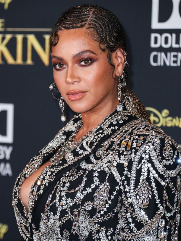 Beyonce braless boobs and areola peek showing off nice cleavage on the red carpet for the premiere of  The Lion King .






