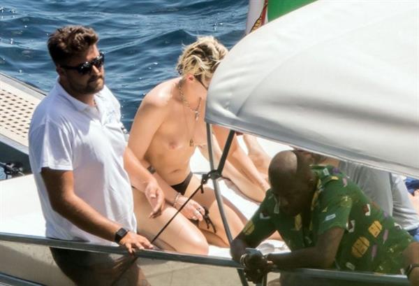 Kristen Stewart nude boobs caught topless by paparazzi tanning on a boat.
