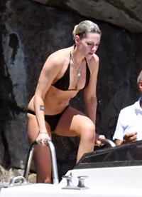 Kristen Stewart nude boobs caught topless by paparazzi tanning on a boat.

