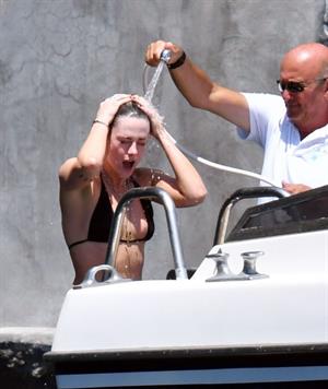 Kristen Stewart nude boobs caught topless by paparazzi tanning on a boat.
