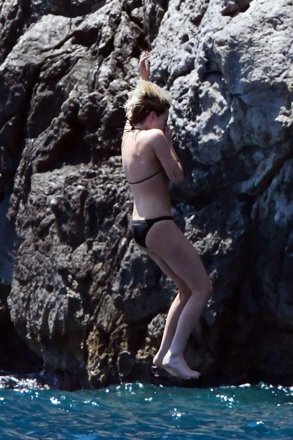 Kristen Stewart nude boobs caught topless by paparazzi tanning on a boat.
