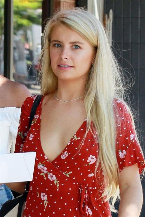 Demi Burnett Pictures Demi Burnett braless boobs in a low cut dress showing nice cleavage seen by paparazzi.