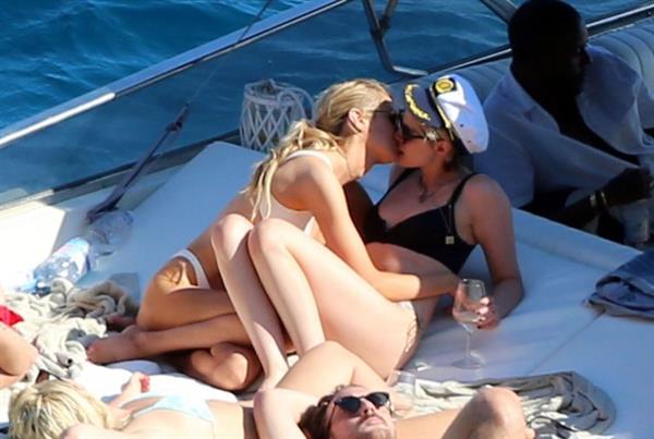 Kristen Stewart and Stella Maxwell sexy lesbians making out on a boat in bikinis seen by paparazzi.










