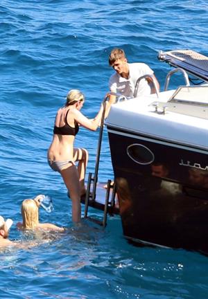 Kristen Stewart and Stella Maxwell sexy lesbians making out on a boat in bikinis seen by paparazzi.











