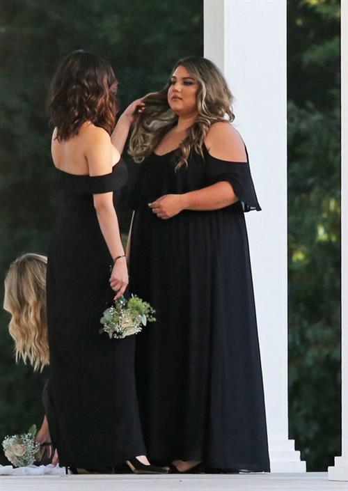 Selena Gomez sexy in a black dress for her cousins wedding showing nice cleavage seen by paparazzi.























