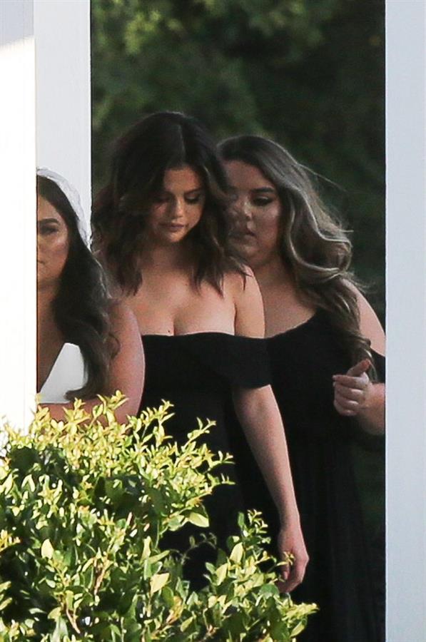 Selena Gomez sexy in a black dress for her cousins wedding showing nice cleavage seen by paparazzi.























