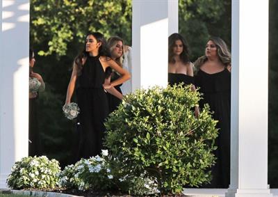 Selena Gomez sexy in a black dress for her cousins wedding showing nice cleavage seen by paparazzi.























