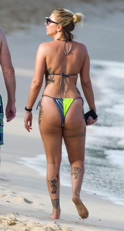 Olivia Buckland sexy in a bikini at the beach seen by paparazzi showing nice cleavage.



