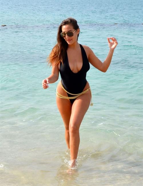 Chloe Goodman Bikini Pictures Chloe Goodman big boobs showing nice cleavage in a low cut swimsuit at the beach seen by paparazzi.