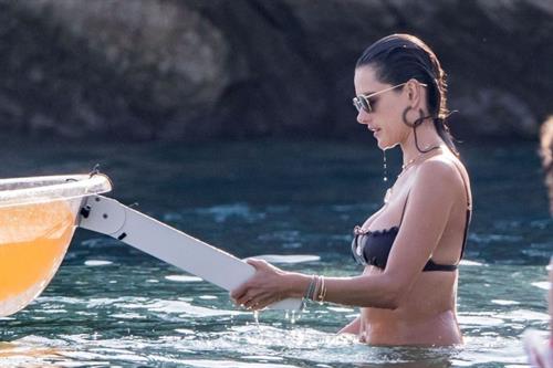 Alessandra Ambrosio Bikini Pictures Alessandra Ambrosio sexy at the beach in a thong bikini and flashing her pussy to her boyfriend seen by paparazzi.