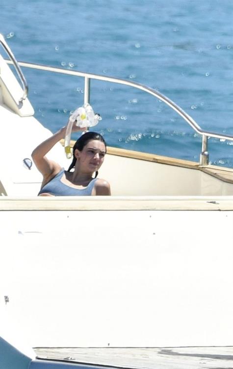 Kendall Jenner Bikini Pictures Kendall Jenner in a sexy bikini swimsuit on a yacht with Kourtney Kardashian seen by paparazzi.