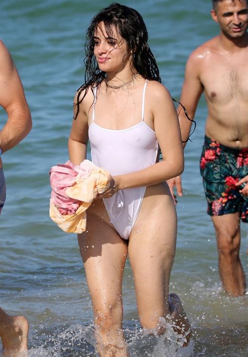 Camila Cabello Bikini Pictures Camila Cabello sexy tits and ass in a wet white swimsuit showing her nipples seen by paparazzi.