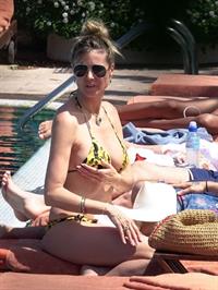 Heidi Klum nip slip in a sexy bikini seen by paparazzi and kissing her husband and flashing her boob.


